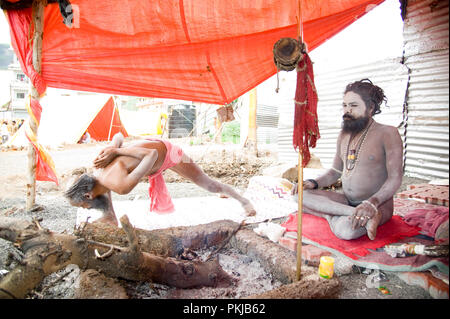 Naga baba sadhu doing yoga at nashik Kumbh Mela maharashtra India Stock Photo