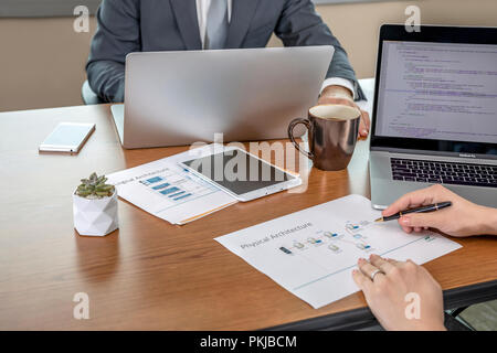 A male and female colleague working together at the office Stock Photo