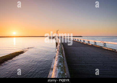 Sunset over the pier of Oostende, on Sunday 2 April 2017, Oostende, Belgium. Stock Photo