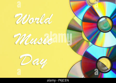 World, international music day. Piles of old and dirty CDs,DVD on pastel background. Used and dusty disk Stock Photo