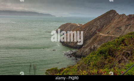 The path to Point Bonita Lighthouse on a typical overcast and foggy day at the San Francisco Bay entrance. Stock Photo
