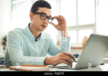 Nice male programmer working on the laptop Stock Photo