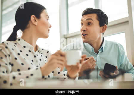 Delighted nice colleagues having a coffee break Stock Photo