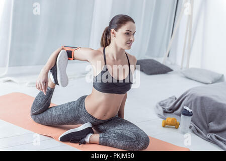 Nice sporty active woman holding her leg Stock Photo