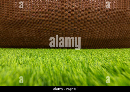 Abstract color between green artifical grasses and brown dasket weave. Stock Photo