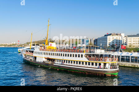 Istanbul, Turkey - April 25, 2017: Local ferry departing Eminonu ferry terminal before sunset Stock Photo