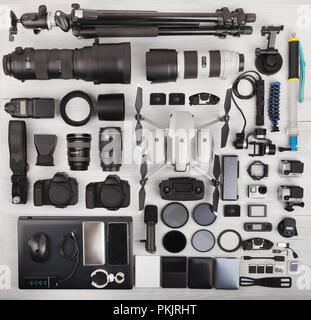 top view of complete travel photographer professional equipment with two DSLR digital camera, drone, memory card, external harddisk, flash, computer l Stock Photo