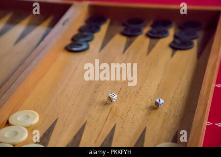 thrown dice on the table while playing backgammon Stock Photo