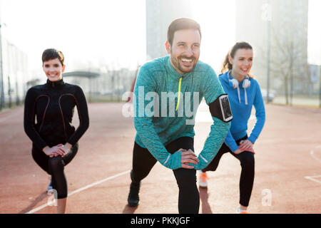 Group of healthy sporty determined friends fitness training toge Stock Photo