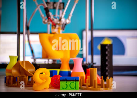 Print orange parts on a 3D printer in printing process Stock Photo