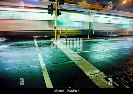 Tram passing down Lygon Street at night in Melbourne's inner northern suburb of Carlton. Stock Photo