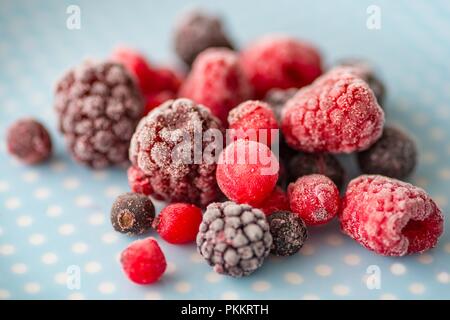 Frozen fruits on the plate, delicious frozen raspberries and blackberries Stock Photo