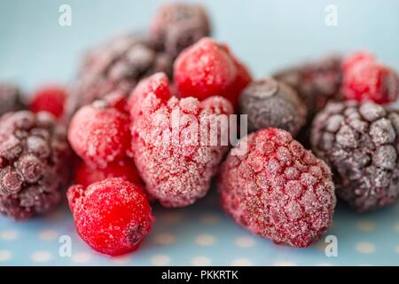 Frozen fruits on the plate, delicious frozen raspberries and blackberries Stock Photo