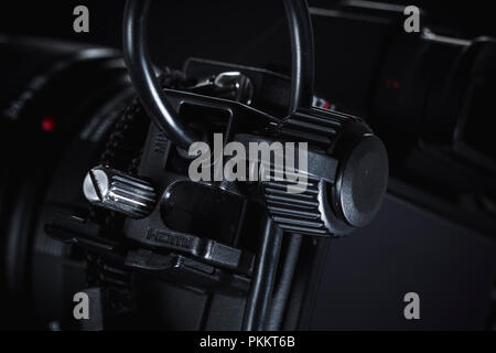 A cable holder on a Sony a7rii mirrorless camera against a dark background. Stock Photo