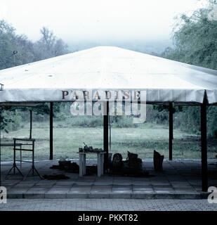 A pavilion tent in sad weather with writing paradise on it. Stock Photo