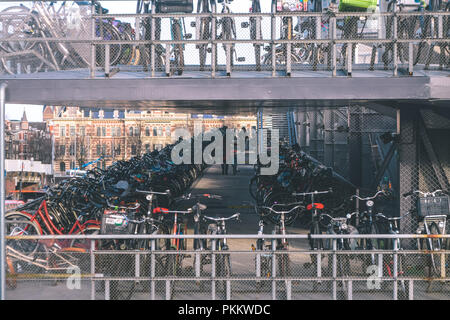 woman leaving her bike in the train station's parking Stock Photo