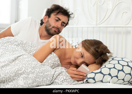 https://l450v.alamy.com/450v/pkkwpc/jealous-man-checks-what-a-woman-with-a-phone-in-hand-is-doing-concept-of-relationship-betrayal-and-jealousy-pkkwpc.jpg