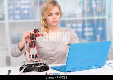 young engineer adjusting intelligence toy robot Stock Photo