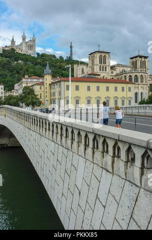 Bridge Bonaparte, over the Saone river in Lyon France, with the basilica Notre dame of Fourviere and cathedral Saint John the Baptist Stock Photo