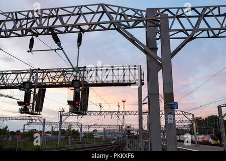 Electric train cables and pylons on Crewe station at sunset, Cheshire ...