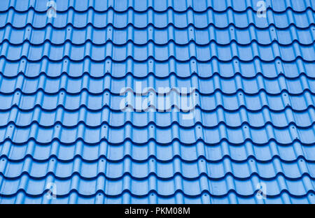 Blue roof tile pattern on the top of the modern house in the summertime. Stock Photo
