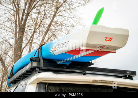 Fort Collins, CO, USA - April 7, 2018: A racing stand up paddleboard by Starboard (2018 All Star model) on roof racks of Toyota 4Runner. Stock Photo