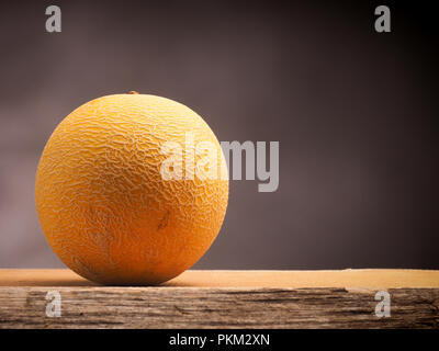 Tasty organic galia melon on a wooden table Stock Photo
