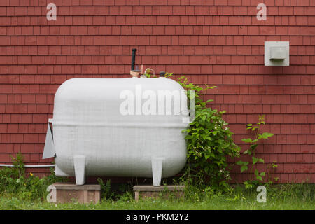 Heating fuel oil tank beside exterior wall. Stock Photo