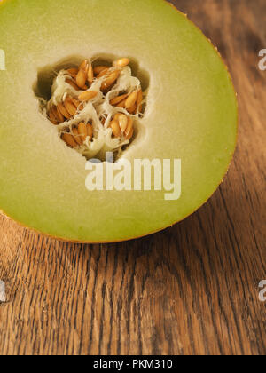 Fresh organic galia melon on a wooden table, healthy food concept Stock Photo