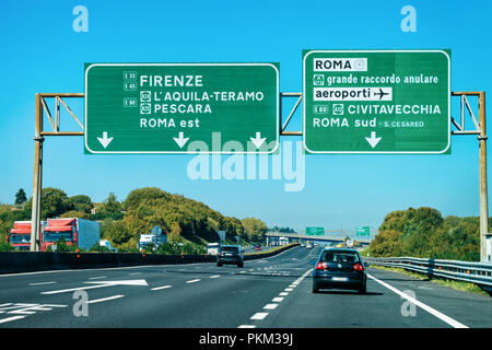 Rome, Italy - October 4, 2017: Cars and green traffic signs to Firenze and Roma in the road in Italy Stock Photo