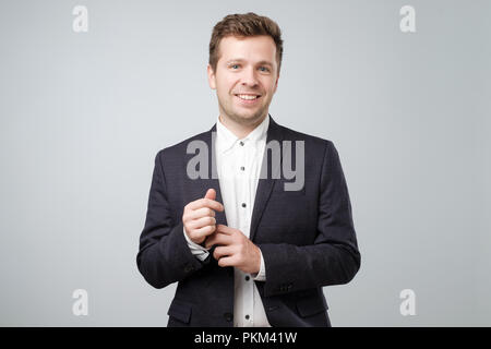 Confident elegant handsome young man standing wearing a nice suit Stock Photo