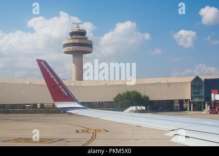 PALMA DE MALLORCA, SPAIN - SEPTEMBER 6, 2018: Norwegian airplane wing with logo outside air control tower on a sunny day on September 6, 2018 in Mallo Stock Photo