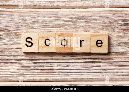 Score word written on wood block. Score text on table, concept. Stock Photo