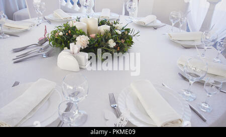 Banquet decorated table, with cutlery. Wedding decor in the banquet hall.Serving of a festive table, plate, napkin, knife, fork. Table setting decoration. Romantic Dinner or other events. Stock Photo