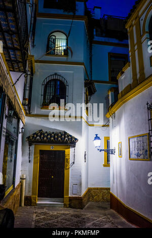 Spain, Seville, Europe,  EMPTY ALLEY AMIDST BUILDINGS IN CITY AT NIGHT Stock Photo