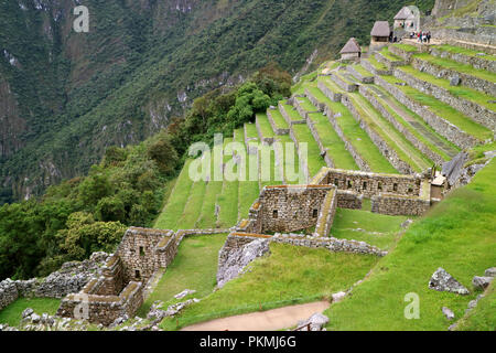 Remains of Residential Area and Agricultural Terraces on the Hillside of Machu Picchu, Famous Archaeological Site in Cusco Region, Peru Stock Photo