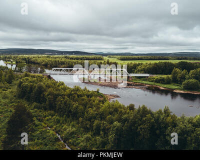 Steel railroad bridge over river in northern Finland seen from the sky Stock Photo