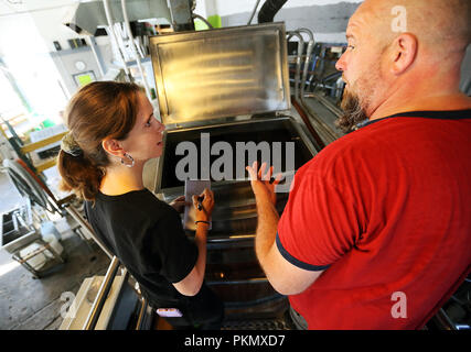 Davenport, Iowa, USA. 14th Sep, 2018. Great River Brewery owner and brewer Scott Lehnert, right talks with Quad-City Times reporter Amanda Hancock about the mash tun Friday, September 14, 2018.mash tun Credit: Kevin E. Schmidt/Quad-City Times/Quad-City Times/ZUMA Wire/Alamy Live News Stock Photo