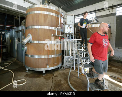 Davenport, Iowa, USA. 14th Sep, 2018. Great River Brewery owner and brewer Scott Lehnert, right walks through the brewing process as he talks with Quad-City Times reporter Amanda Hancock about the brewing process Friday, September 14, 2018. Credit: Kevin E. Schmidt/Quad-City Times/Quad-City Times/ZUMA Wire/Alamy Live News Stock Photo