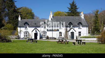 Bathed in bright spring sunshine, the 18th century Tigh-an-Truish Inn undergoing alterations prior to the season opening. Seil Island, Argyll Stock Photo