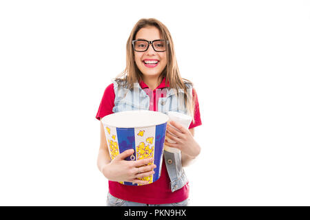 Cheerful bright woman in glasses holding bucket of popcorn and soda cup being ready for movie Stock Photo