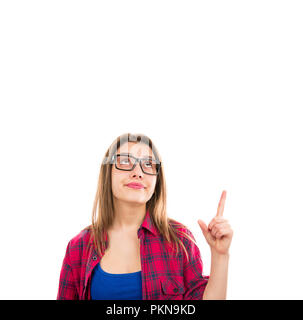 Pretty young woman in glasses pointing up with finger having idea and indicating solution isolated on white background Stock Photo