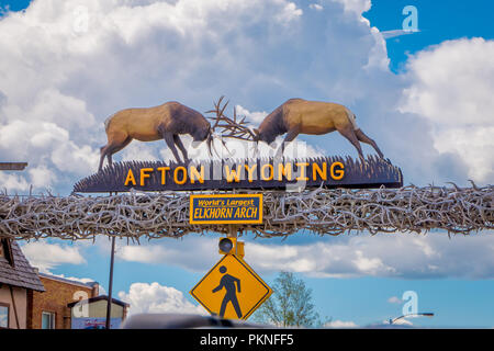 Afton, Wyoming, United States - June 07, 2018: Outdoor view of the world's larges elkhorn arch at the entrance of the town in a cloudy sky background during a summer season Stock Photo