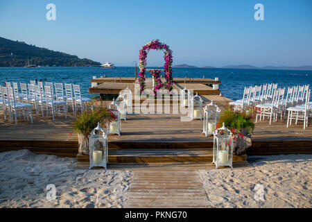seaside wedding flowers, white chairs white candlesticks Stock Photo