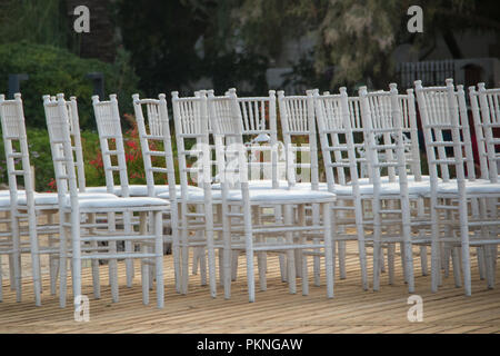 seaside wedding flowers, white chairs white candlesticks Stock Photo