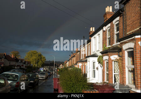 Rainbow over a street and houses in Reading, Berkshire, England Stock Photo