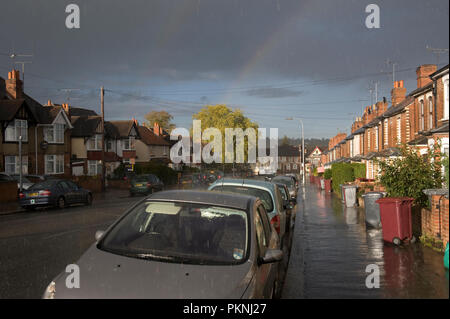 Rainbow over a street and houses in Reading, Berkshire, England Stock Photo