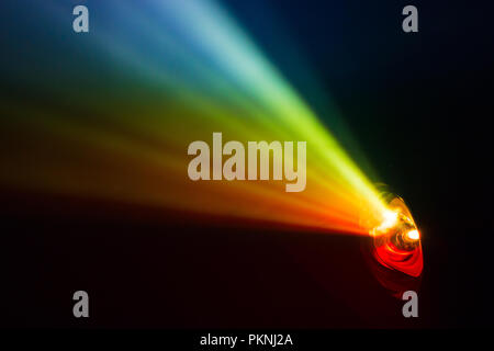 beautiful rainbow color wide lens projector with light beam for movie and cinema at night . smoke texture spotlight . screening for multimedia . black Stock Photo