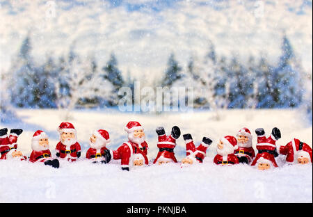 A large number of Santa Claus figures in front of a winter landscape Stock Photo
