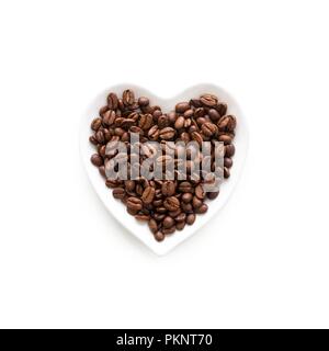 Coffee beans in a heart shape bowl. Stock Photo